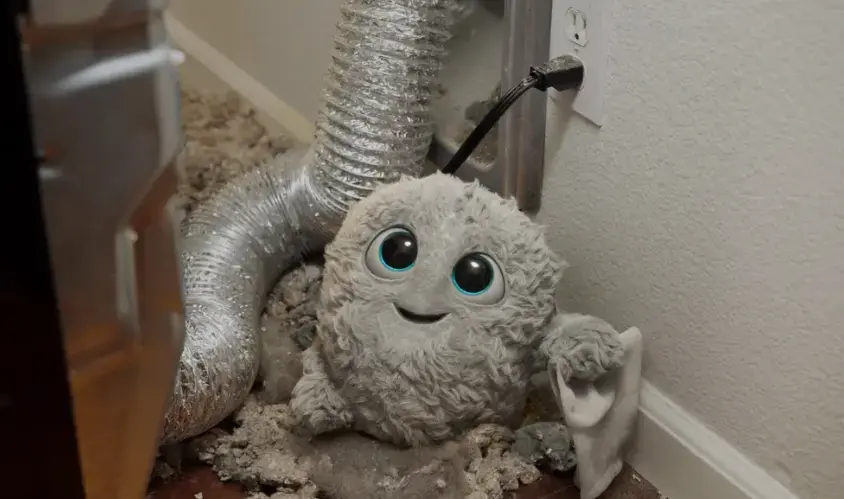 COIT IT logo mascot standing infront of a dryer vent